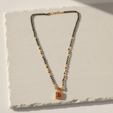 Elegant Black Bead Mangalsutra with Sparkling CZ Bow and Ruby Pendant