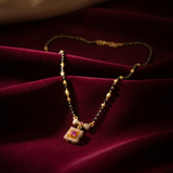 Elegant Black Bead Mangalsutra with Sparkling CZ Bow and Ruby Pendant